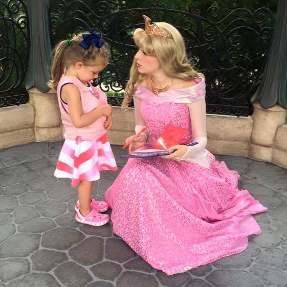 Girl wearing pink kool max toddler cooling vest talking to a disney princess
