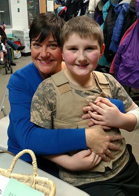 Boy with his mom wearing a khaki Cool Kids cooling vest