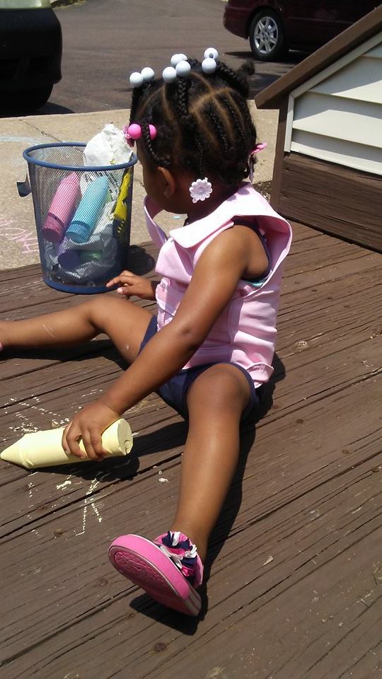 Girl wearing a pink Cool Kids toddlers cooling vest playing with chalk