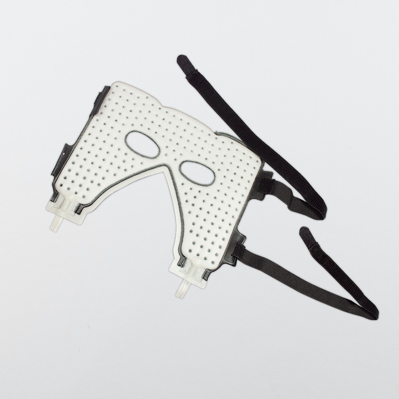 The cold circulating water therapy face mask placed on a table 