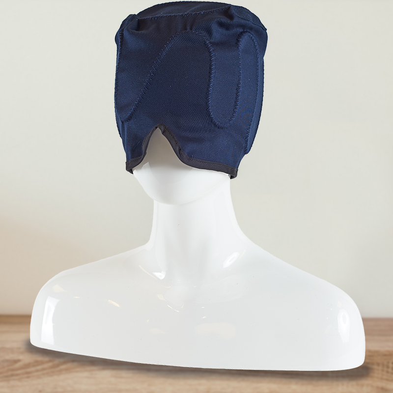 Woman smiling wearing a cold neck and scalp cold relief head cap over her eyes