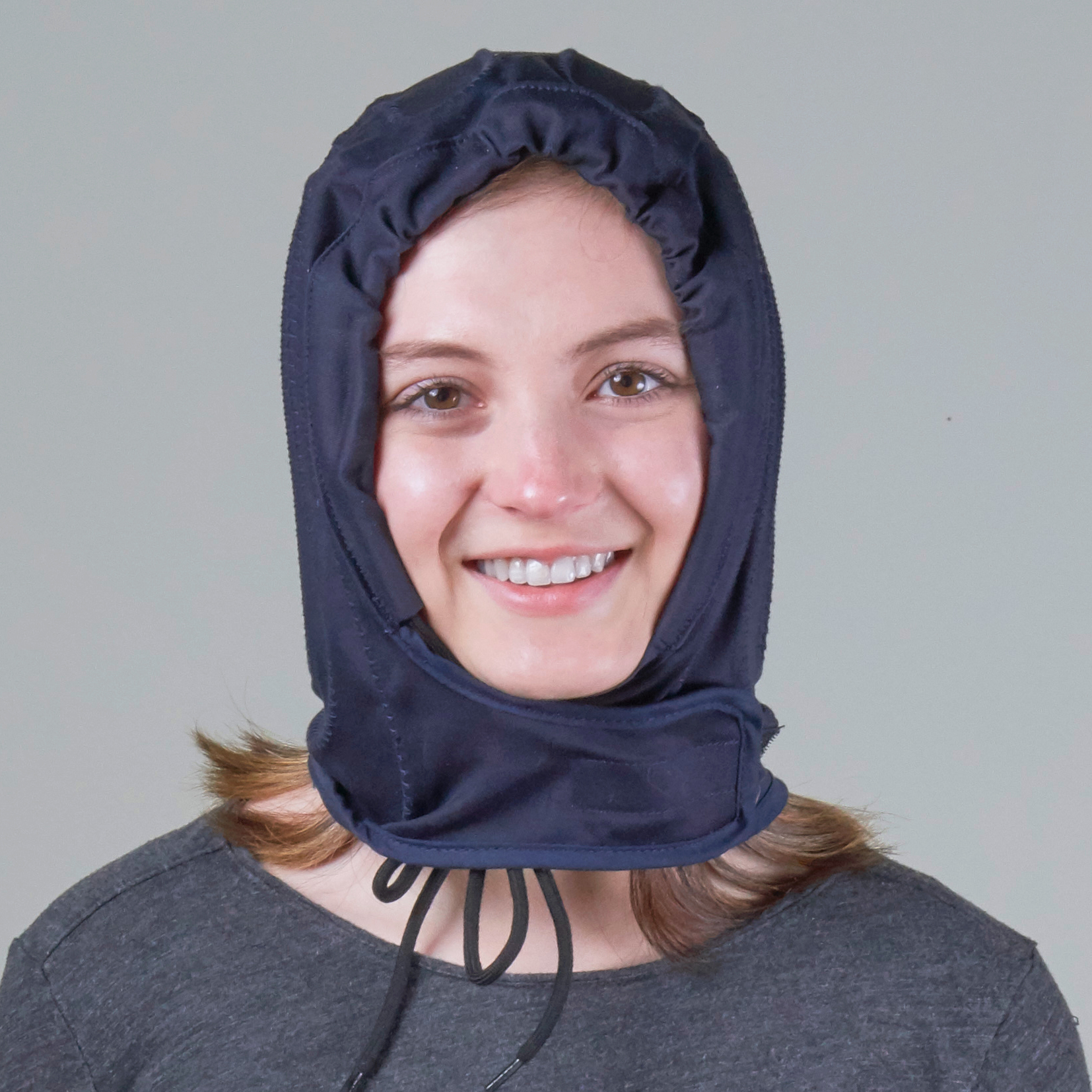 Woman wearing a headache relief cold therapy water cooling compression pack pad on her head back side view