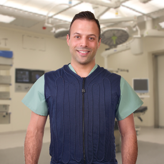 Man wearing a blue cool flow fitted circulating water cooling vest