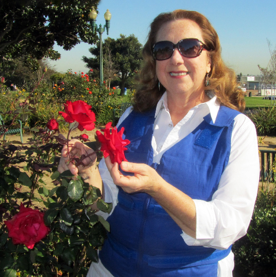 Woman wearing a blue adjustable cooling vest outside