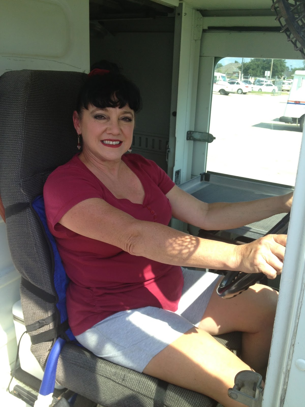 Woman in a mail truck sitting on a Cool Flow Industrial circulating cold water cooling seat