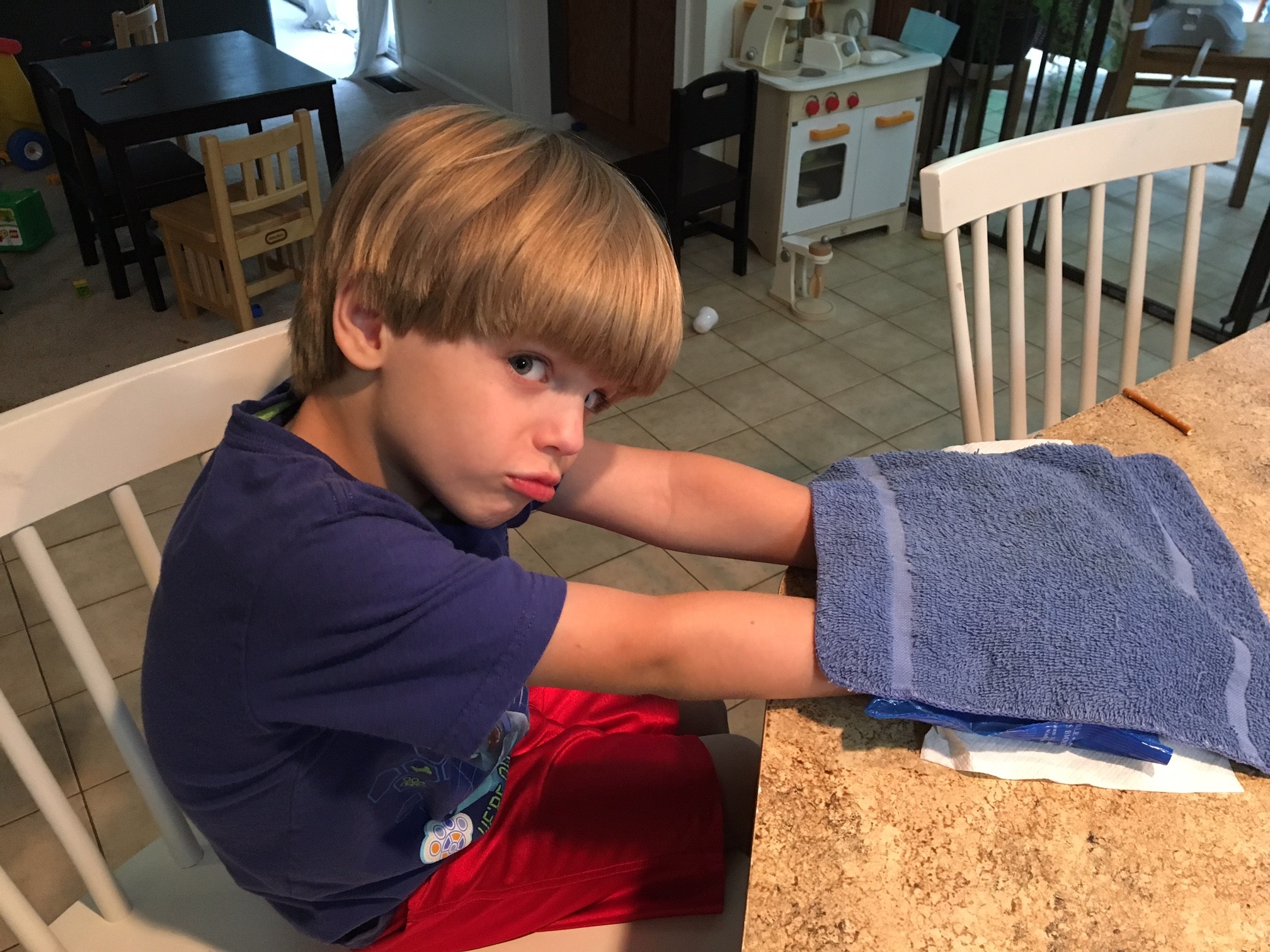 Boy putting his hands on a Soft Ice Cold/Hot therapy pack