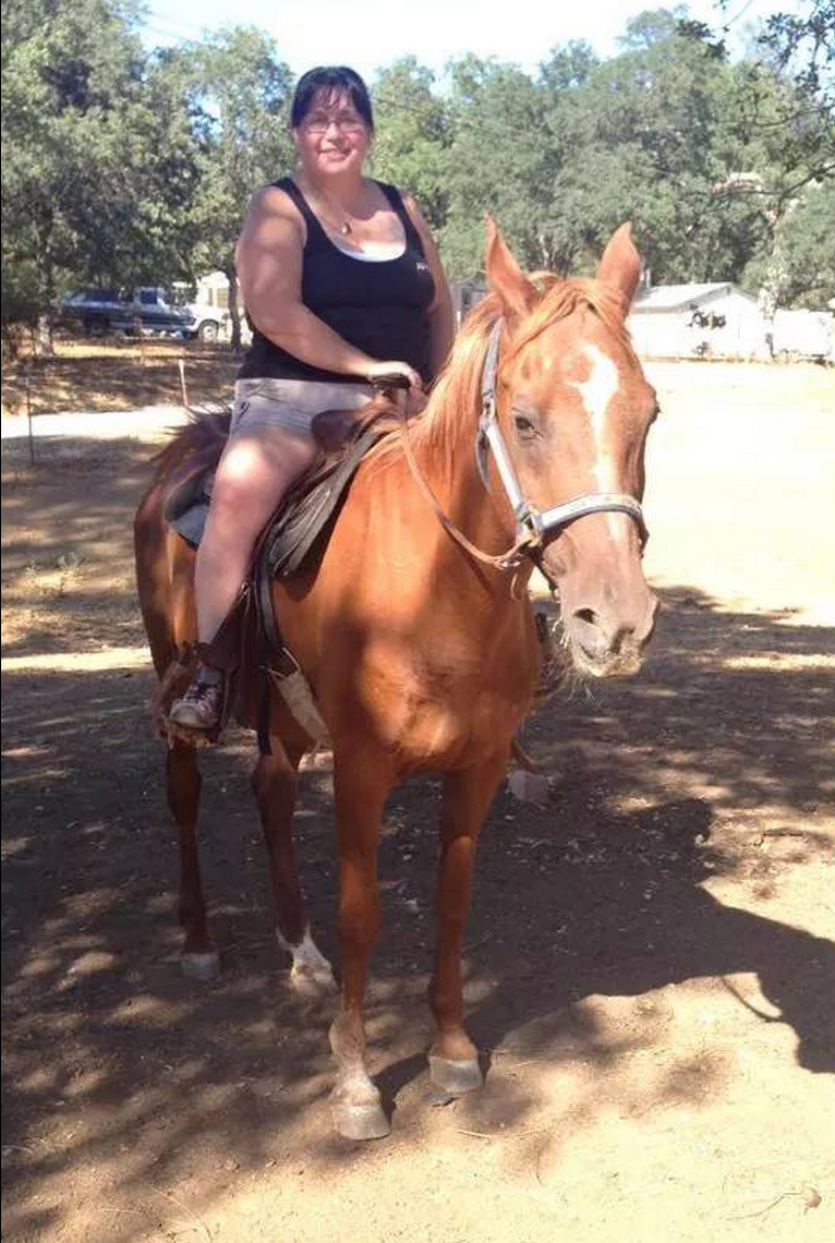 Woman on horseback wearing a kool max secrets vest