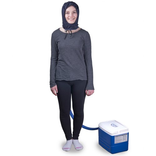 A young woman is standing upright wearing an Active Ice3.0 Cold Water Therapy Head Cap System, the Head Cap is connected to the tubing of a 9 quart reservoir