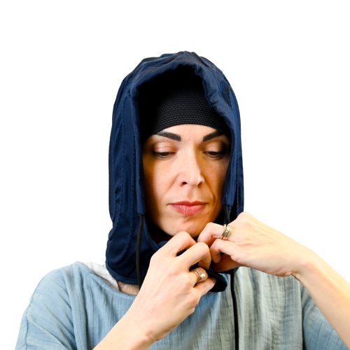 A young woman is standing upright wearing an Active Ice3.0 Cold Water Therapy Head Cap System, the Head Cap is connected to the tubing of a 9 quart reservoir