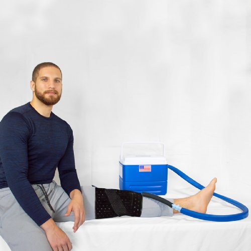 an athletic man hooked up to a full circumference cold water knee system 