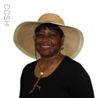 Woman wearing a khaki straw hat with a cool comfort evaporative cooling insert