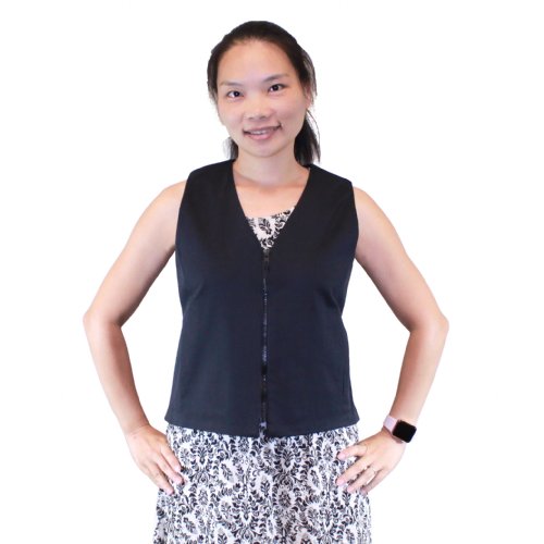 a woman wearing a khaki fashion vest two koolmax packs are shown next to her
