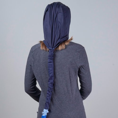 Woman wearing a migraine relief cold therapy water cooling compression pack pad on her head side view