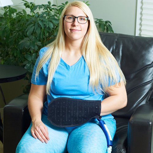 Woman wearing ice cold water cooling pack pad on her hand and wrist