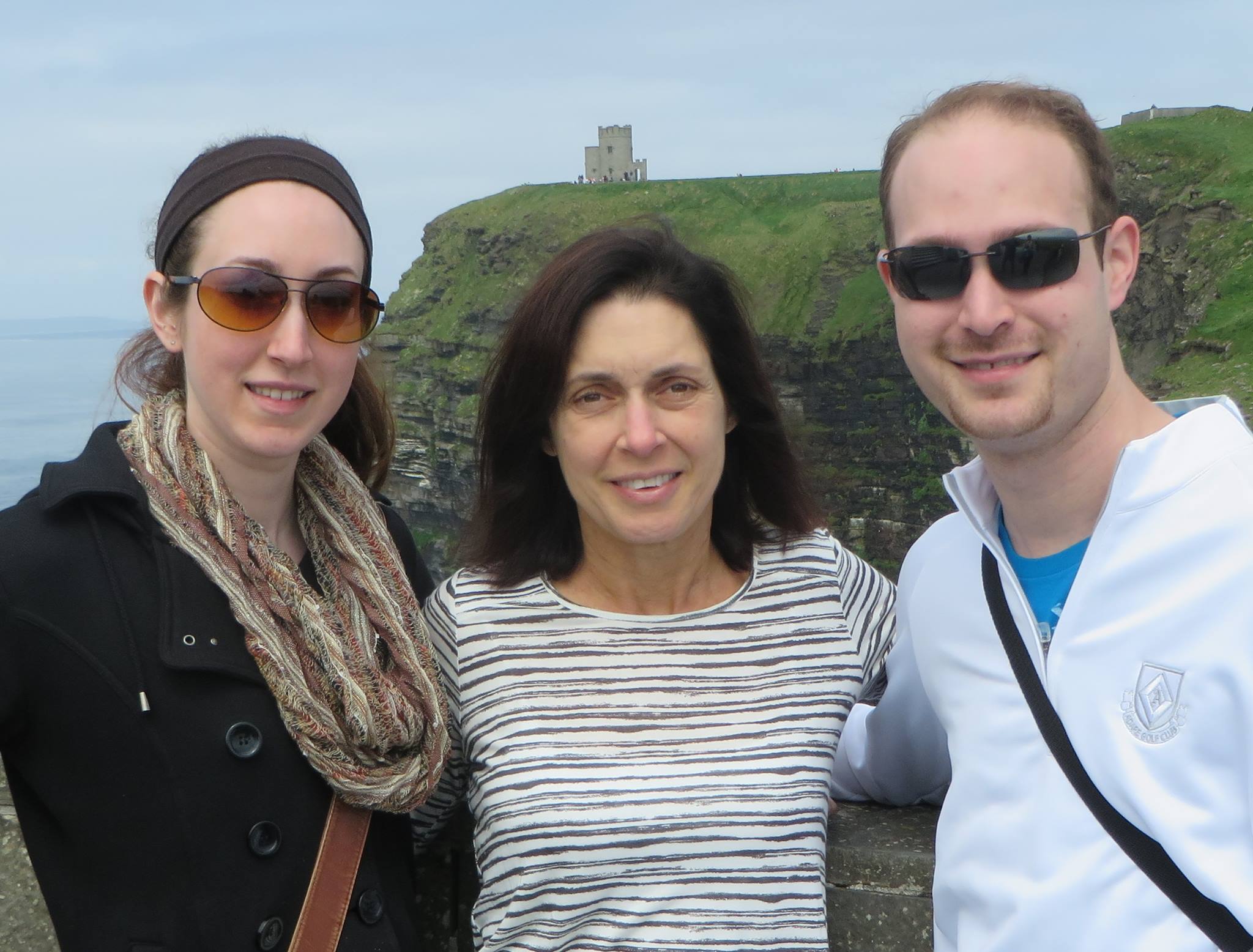 Two women and a man on a hill in Ireland