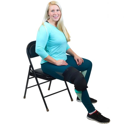 Atletic injured woman with hot and cold therapy ice pack brace wrapped on knee