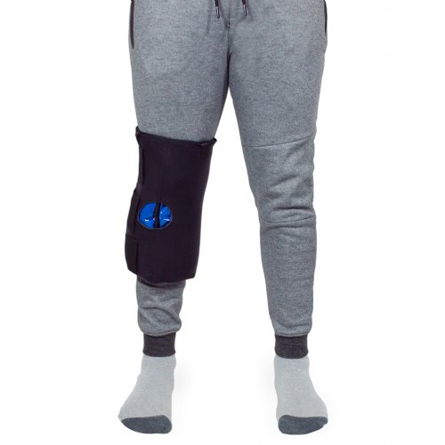 Atheletic man with hot and cold therapy ice pack brace wrapped on knee