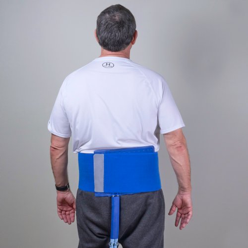 Man wearing ice cold water compress pad on his lower back