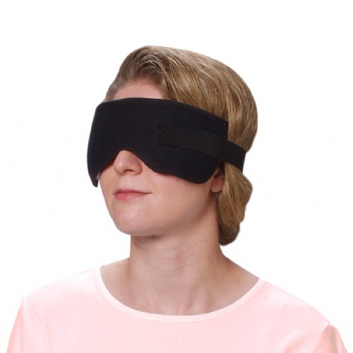 a woman wearing a moist heat therapy pain sinus and eye wrap around her eyes 