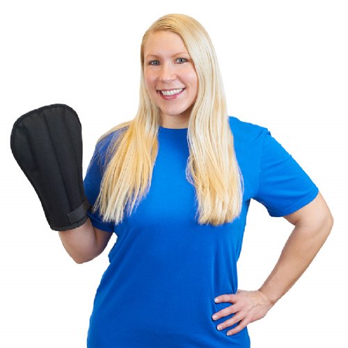 A woman wearing a moist heat therapy pain wrap for the hand and wrist