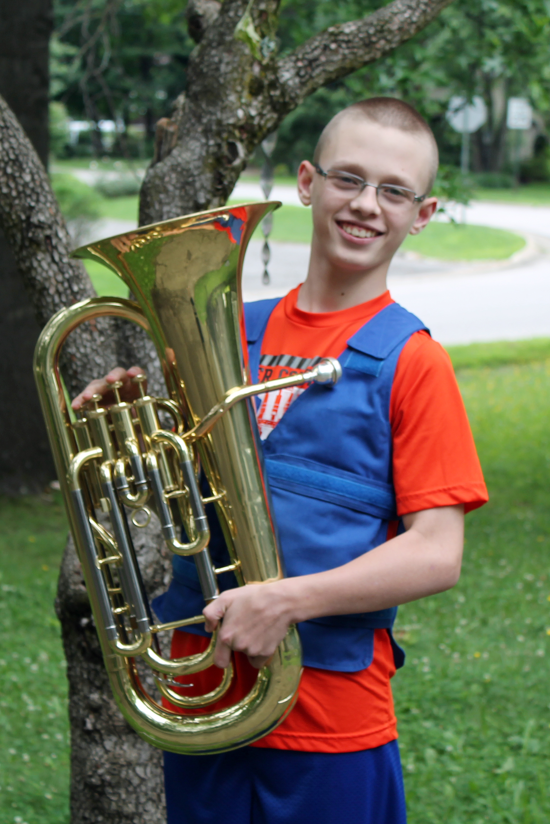 Boy with a tuba wearing a Cool Kids adjustable cooling vest