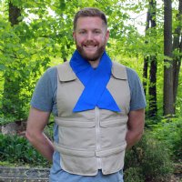 Man wearing khaki adjustable zipper front cooling vest with blue cooling neck wrap