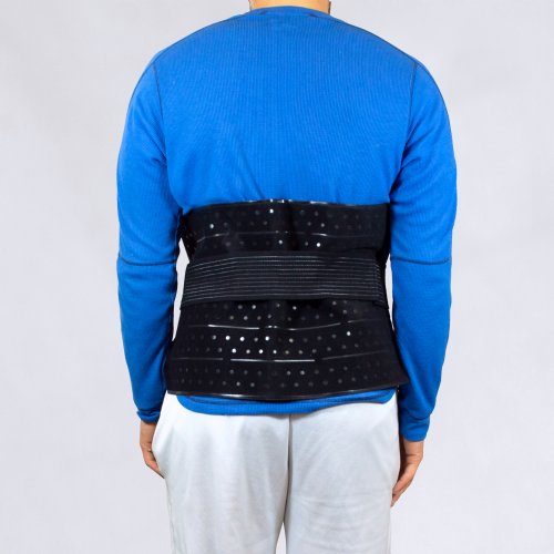Athletic man wearing a large ice therapy cooling pack water pad compressed on his lower back