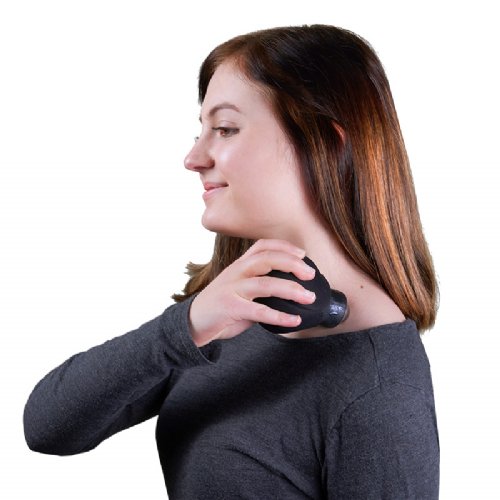 a young woman applying a neck massager on her shoulder