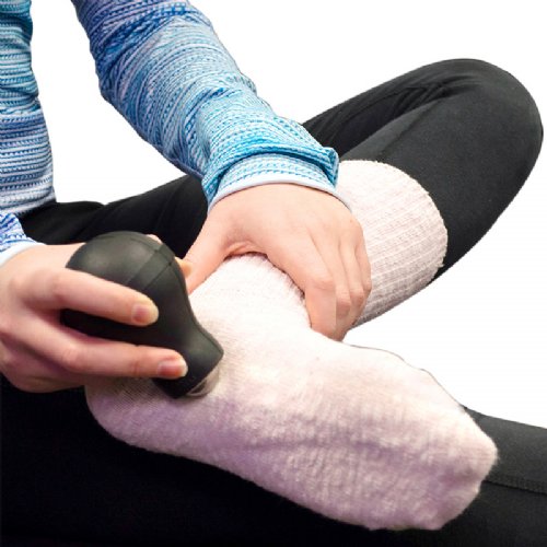 A foot is shown with a deep tissue roller ice massager pressed into its arch