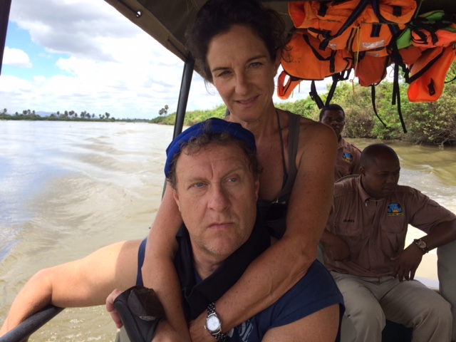 Man wearing a cool comfort cooling bandana with a woman in a boat on a river