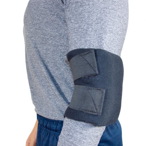 Atheletic man wearing hot and cold ice pack with elbow cold wrap