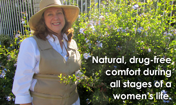 Woman wearing a straw hat and kool max adjustable zipper front cooling vest in a garden